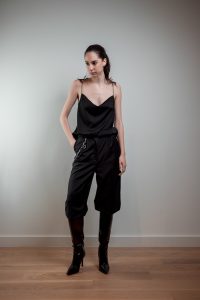 JAGYCH AW 25 ESSENTIALS BRUTAL REFINEMENT STRAP BLOUSE IN BLACK CRYSTAL CROSS EARINGS TROUSERS CHAIN